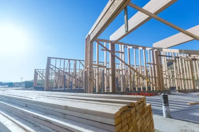 Wooden framework of a house under construction against blue sky