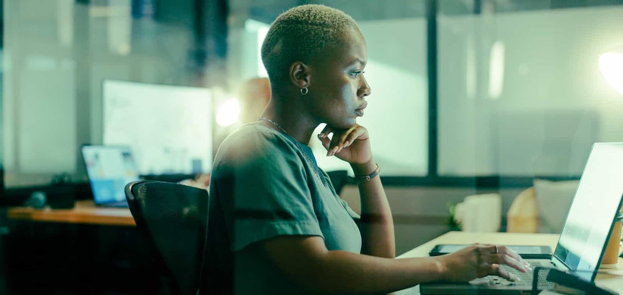 Woman looking at computer with strong focus. 